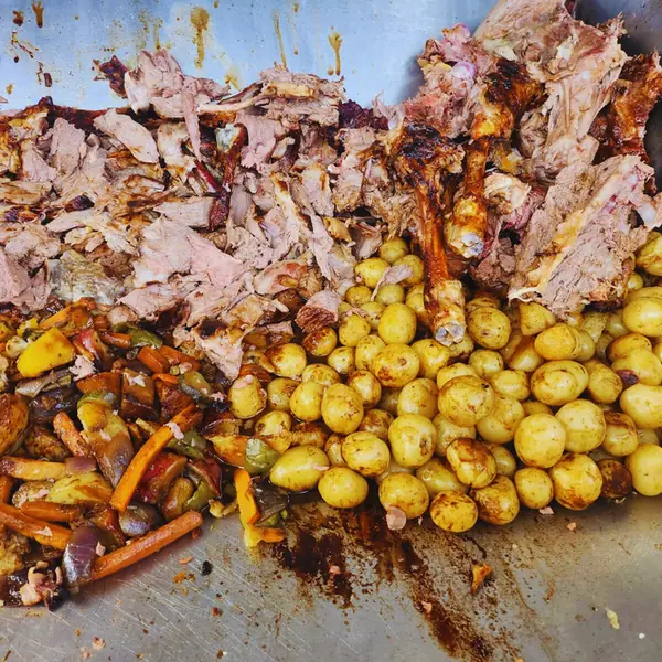 Carved roast meat with golden roast potatoes